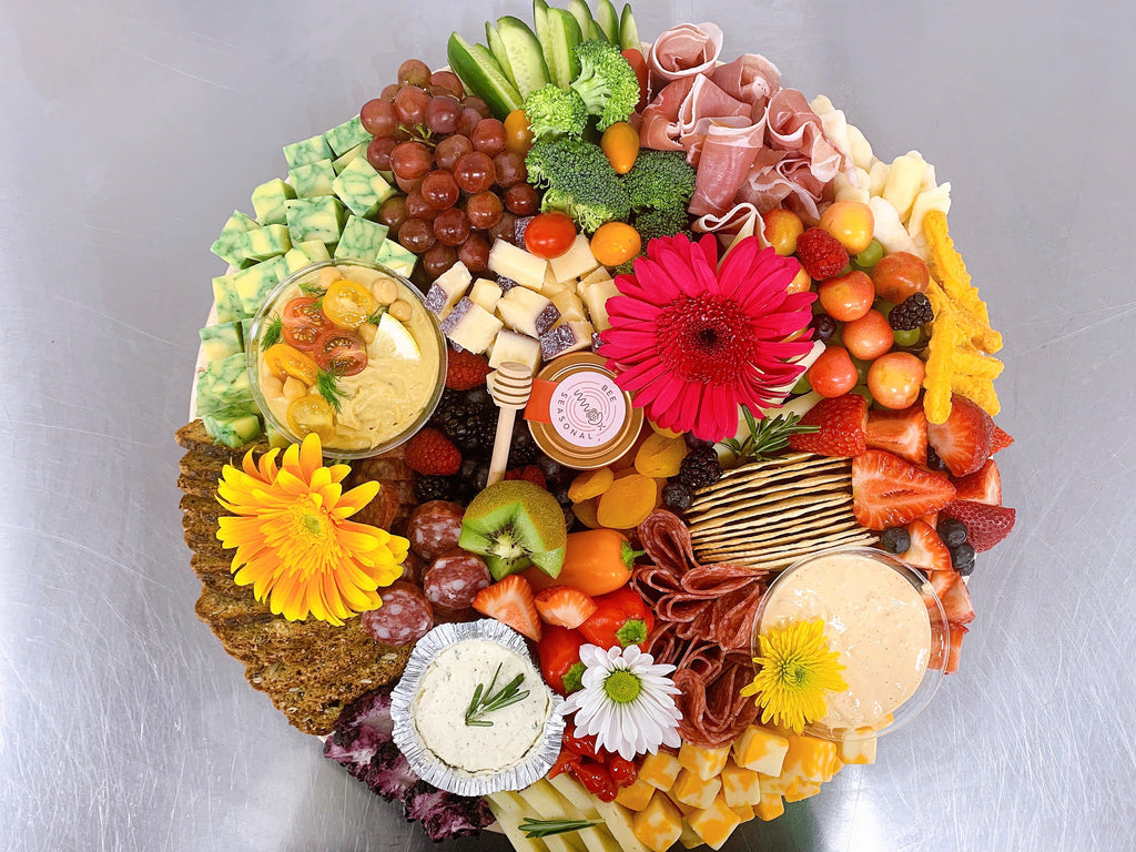 Gourmet charcuterie board with artisanal cheeses, cured meats, fruits, and nuts