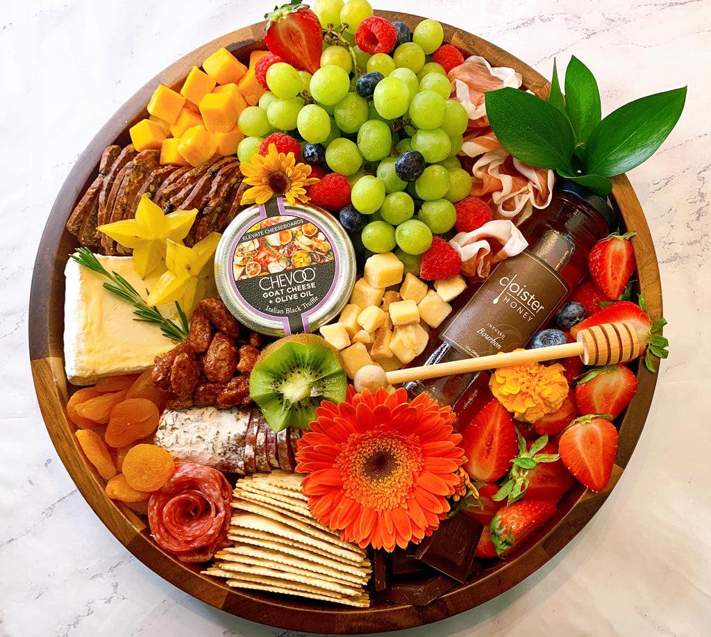 Gourmet charcuterie board with artisanal cheeses, cured meats, fruits, and nuts