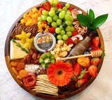 Gourmet charcuterie board with artisanal cheeses, cured meats, fruits, and nuts