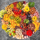 Gourmet charcuterie board with artisanal cheeses, cured meats, fruits, and nuts