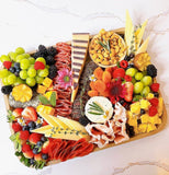 Gourmet charcuterie board with artisanal cheeses, cured meats, fruits, and nuts