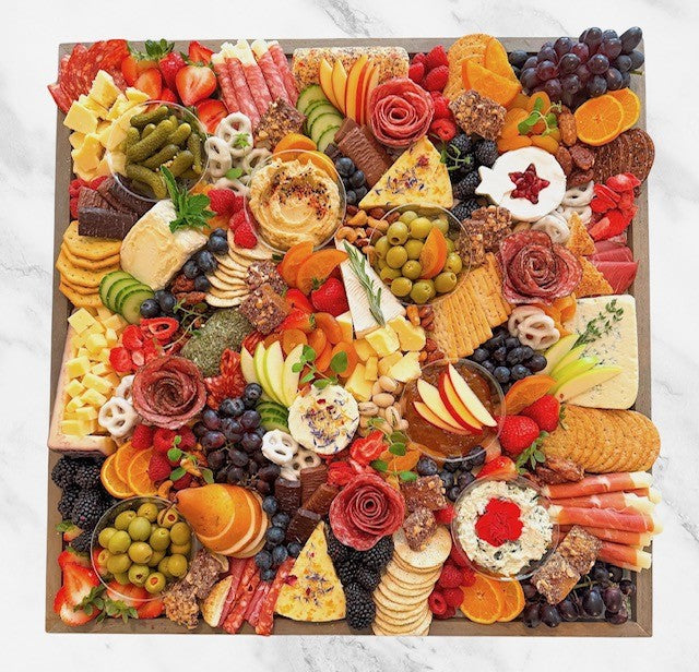 Gourmet charcuterie board with artisanal cheeses, cured meats, fruits, and nuts